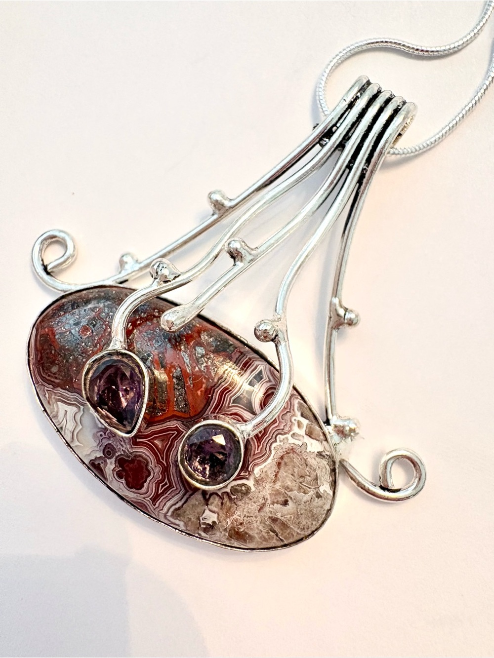 2 inch, 925 marked, Crazy Lace  Agate,  and Amethyst  pendant on silver chain.